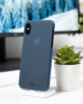 Phone in a blue case beside a succulent
