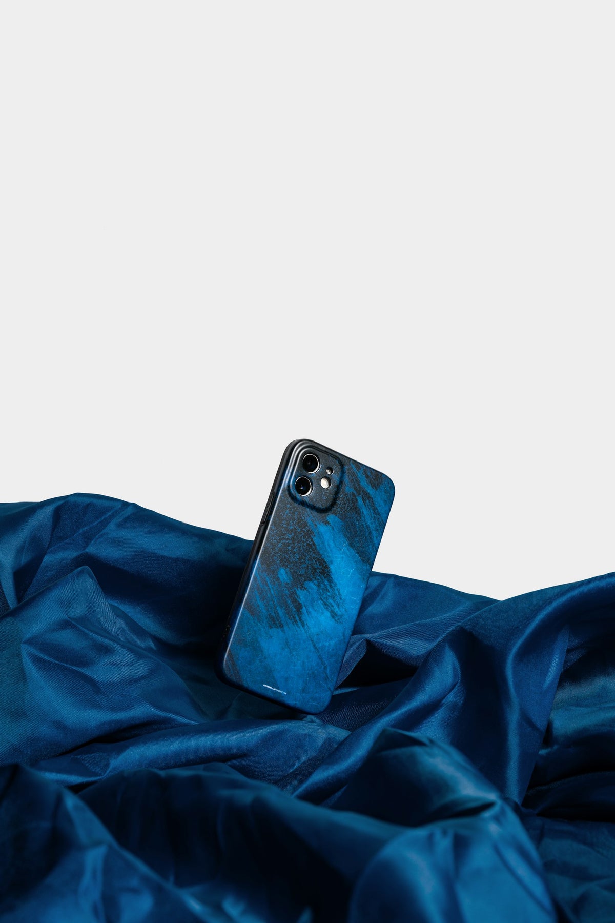 Cased phone resting on a blue cloth